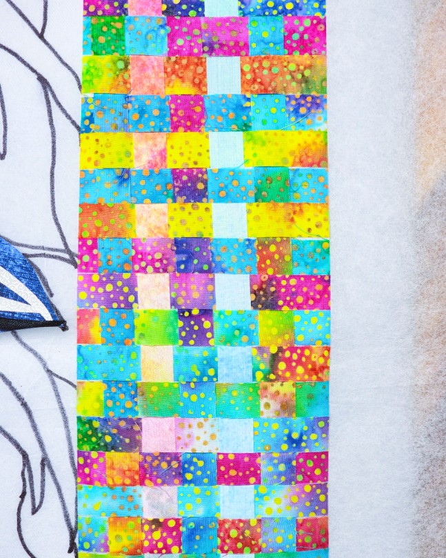 Batik fabric cut into quarter-inch strips and woven into Spyger's collar