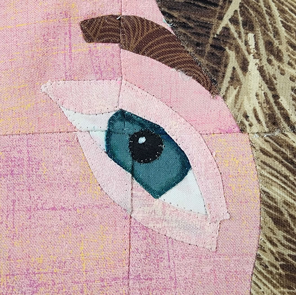 Close-up of an eye in a quilted piece