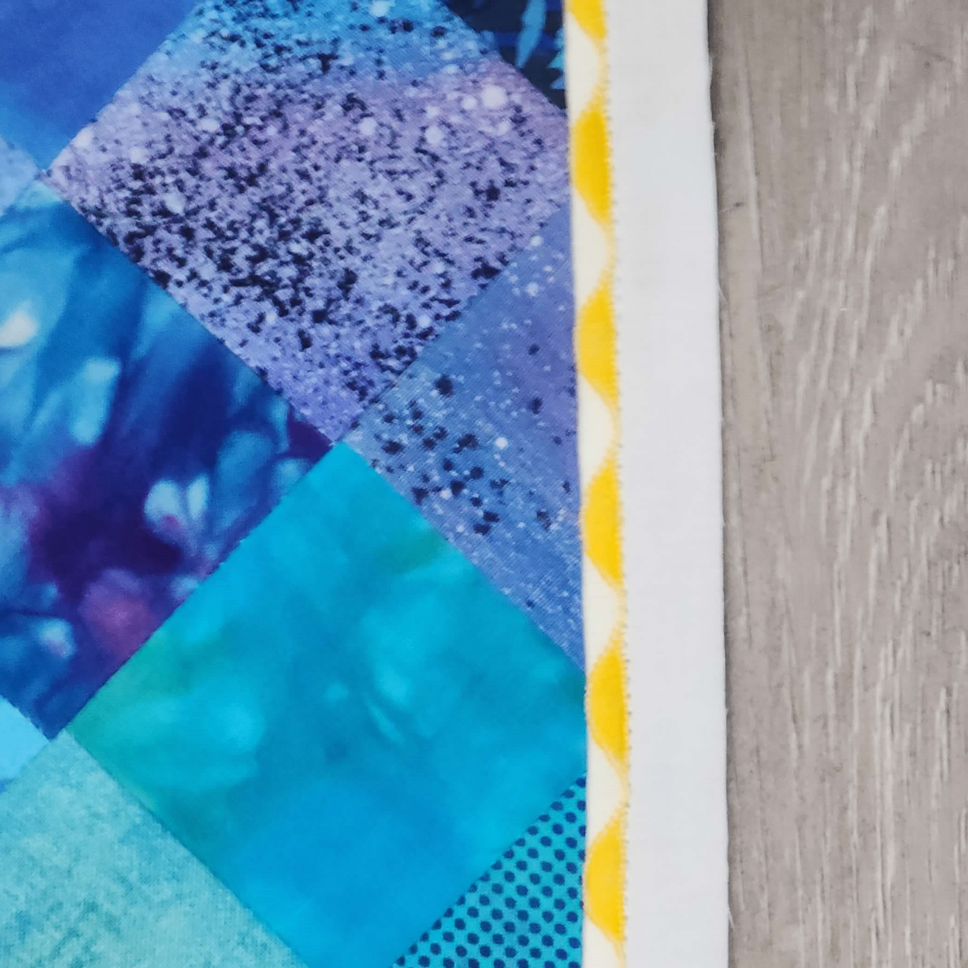 Close-up of quilt edge with yellow piping